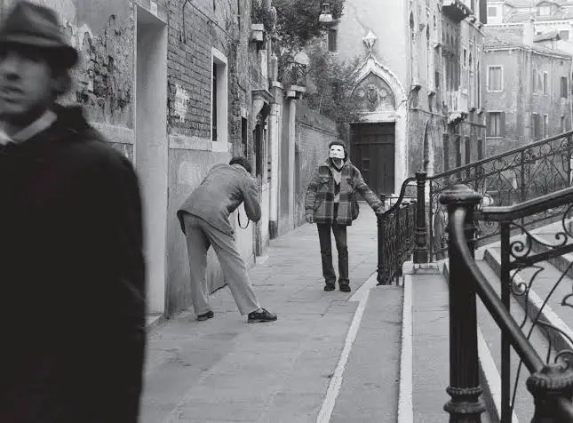 Sophie Calle following a man in a foggy Venice alley, conceptual art.